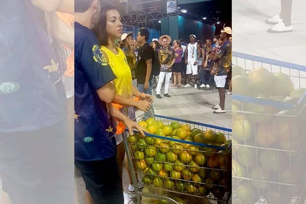 Em ensaio, Paraíso do Tuiuti distribui laranjas na Marques de Sapucaí