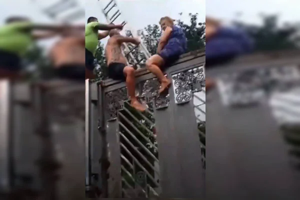 Vídeo: idosa de 80 anos sobe em portão para fugir de enxurrada no DF