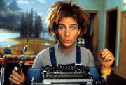 Yahoo Serious sits in front of a typewriter in a scene from the film 'Mr. Accident', 2000. (Photo by United Artists/Getty Images)