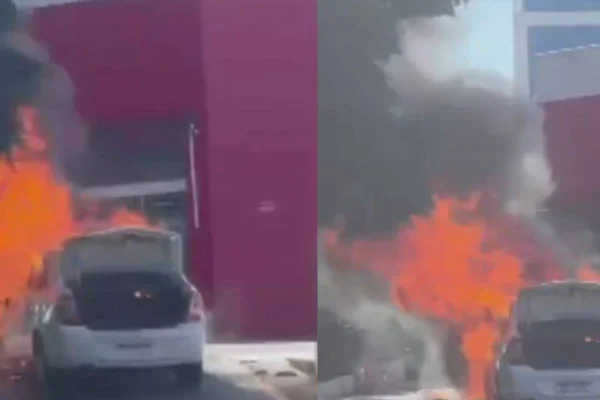 Carro em chamas, pegando fogo em frente a uma farmácia - Metrópoles