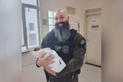 Police officer Felipe Viot holding a baby