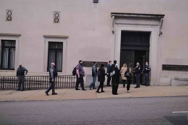 RICHMOND, VA - JANUARY 15: Staff of the Supreme Court are allowed back into the building after police cleared the building of all bomb threats. on January 15, 2021 in Richmond, Virginia. Police in Virginia state capitol responds to a bomb threat to the state Supreme Court building