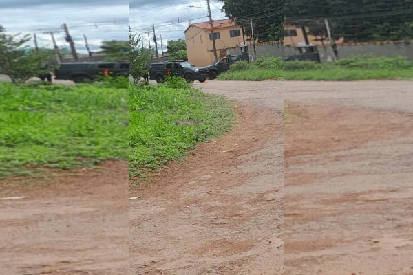 Viaturas da PMGO paradas em frente a uma casa em zona rural