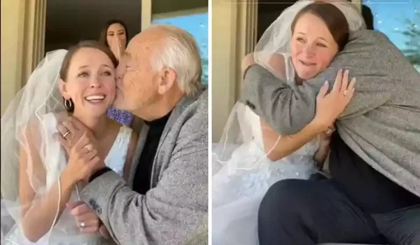 Na imagem, um pai e uma filha, vestida de noiva, se abraçam - Metrópoles