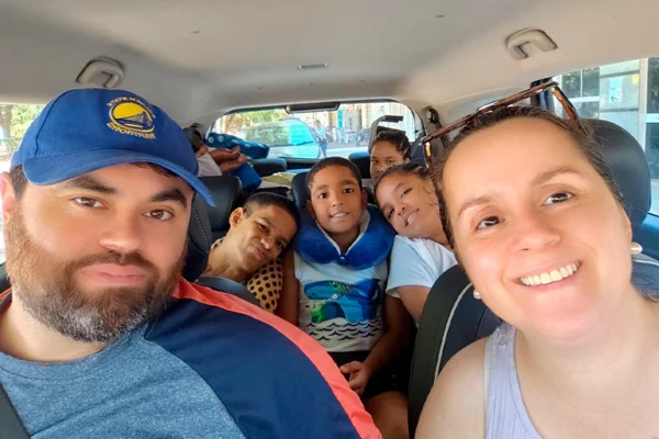 imagem colorida de familia que adotou jovem com paralisia cerebral