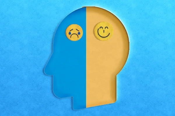 Ilustração colorida, de silhueta humana com "carinha" triste e feliz dividindo o cérebro - Metrópoles