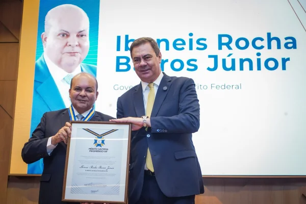 Ibaneis com seu reconhecimento sendo entregado pelo presidente do fecomércio