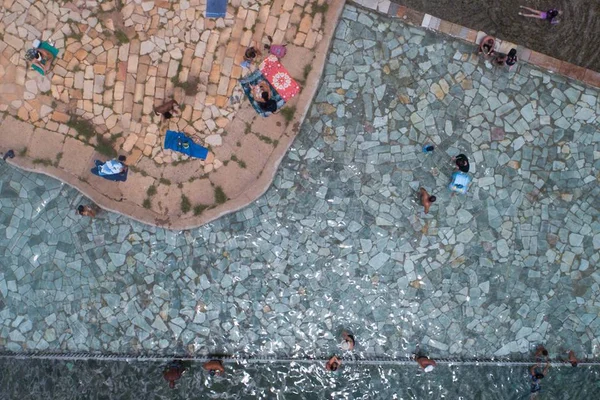 Chão de pedras ao lado de piscina vistos de cima