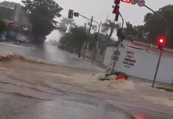 imagem colorida motociclista arrastado enxurrada