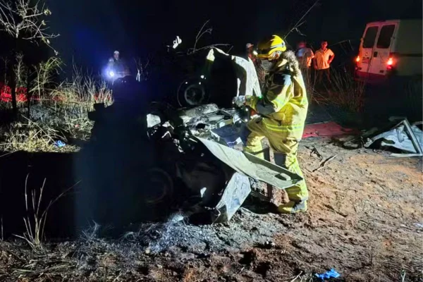 Foto colorida de bombeiro próximo às ferragens de carro - Metrópoles