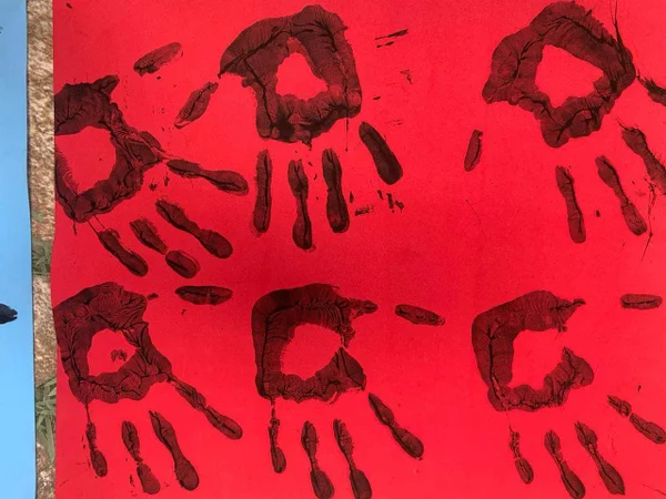 Cartaz vermelho feito por grupo que protestou em vigília contra a guerra na Ucrânia em embaixada russa mostra mãos de tinta - Metrópoles