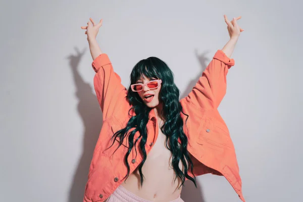 Mulher usando jaqueta na cor Peach Fuzz, eleita a cor do ano pela Pantone - Metrópoles