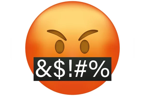 Ilustração colorida de emoticon vermelho com placa preta na boca simulando vários palavrões ditos pela figura - Metrópoles.