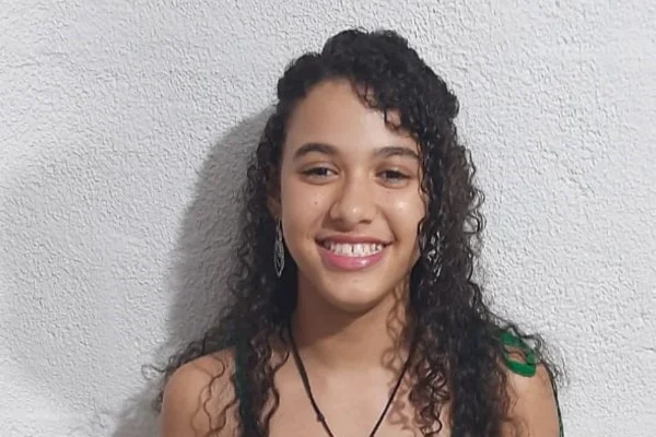 Imagem colorida de menina sorrindo. Metrópoles