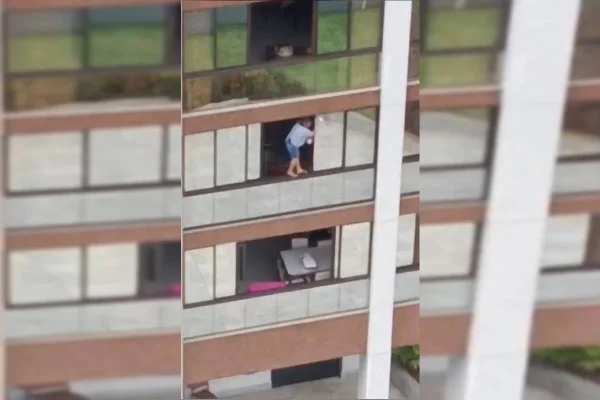Mulher limpa vidro de apartamento sem nenhum equipamento em Águas Claras