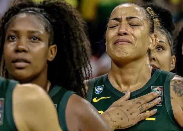 Erika chora com a mão no peito antes do jogo de despedida pela Seleção de Basquete