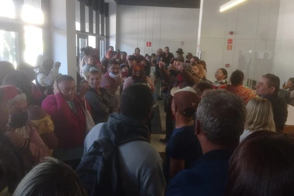 Pessoas reunidas em sala grande