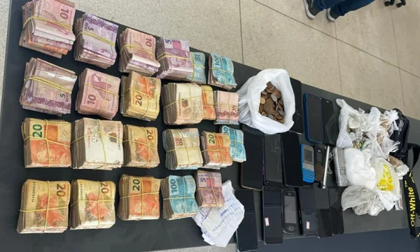 foto colorida de dinheiro, celulares e drogas apreendidos com suspeito de tráfico em Santos; no total, foram encontrados R$ 58 mil em dinheiro vivo - Metrópoles