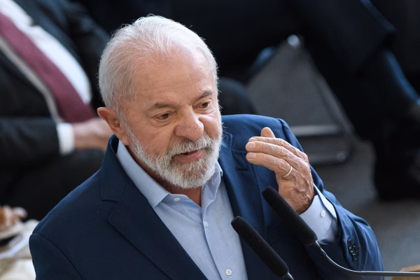 Lula durante discurso no Planalto, defendendo Fernando Haddad e criticando a gestão anterior.