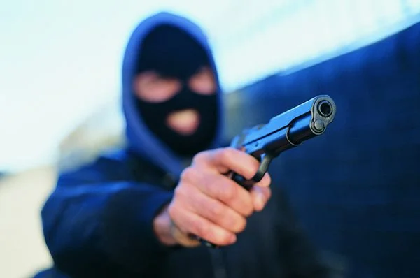 Homem mascarado com uma arma nas mãos- Metrópoles