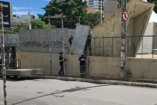 Homens retiram tapume que cerca a Praça Roosevelt, em São Paulo