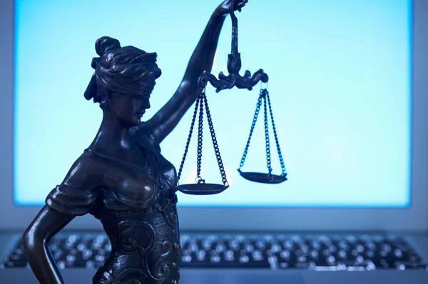 Foto de um computador com o símbolo da Justiça