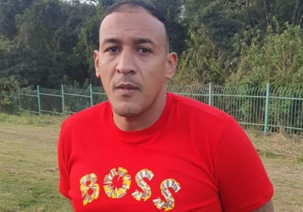 Em foto colorida foragido da Justiça e membro do PCC usa camiseta vermelha com a estampa Boss. Registro feito lofo após sua prisão - Metrópoles