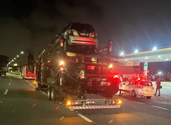 Imagem de carros sendo rebocados em caminhão - Metrópoles