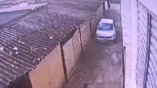 Imagem de carro branco passando por corredor de condomínio - Metrópoles