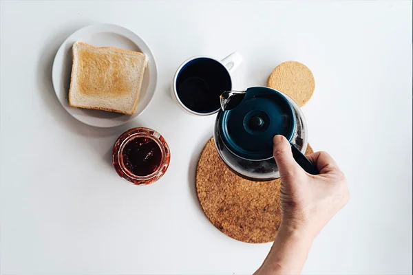 Imagem colorida de uma mão masculina servindo café - Metrópoles