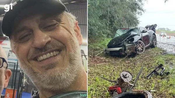 homem sorrindo ao lado de Porscge destruída