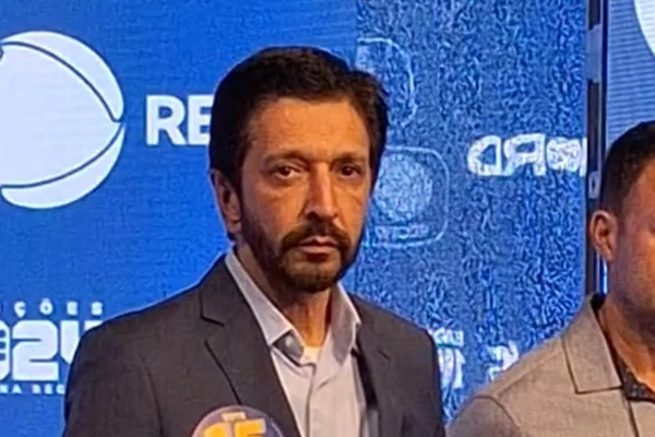 Imagem colorida traz Ricardo Nunes, homem branco, de cabelo e barba pretos, vestindo terno cinza e camisa, em foto do peito para cima - Metrópoles