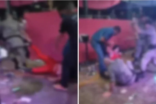 Foto colorida do momento em que pms puxam uma mulher pelo pé em briga generalizada em Goiás - Metrópoles