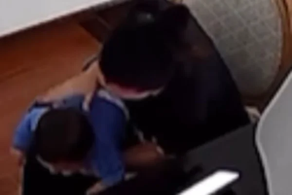 Imagem colorida de mulher desengasgando bebê de 8 meses com tapas nas costas. Metrópoles