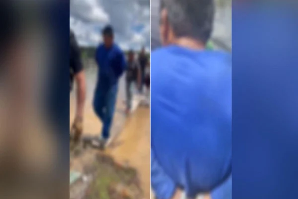 Imagem borrada do homem sendo preso o estaleiro em que ele trabalhava, às margens do Rio Negro - Metrópoles