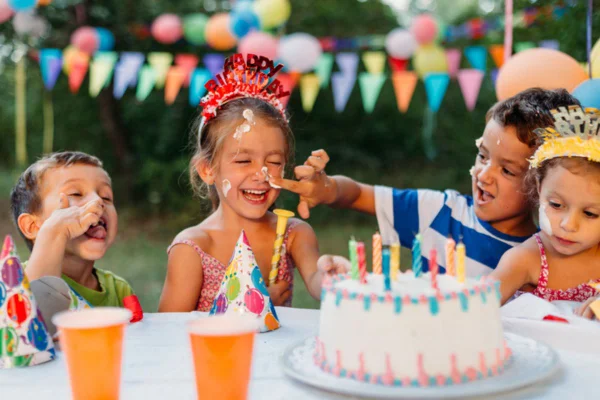 Imagem colorida de crianças juntas em festa de aniversário no quintal