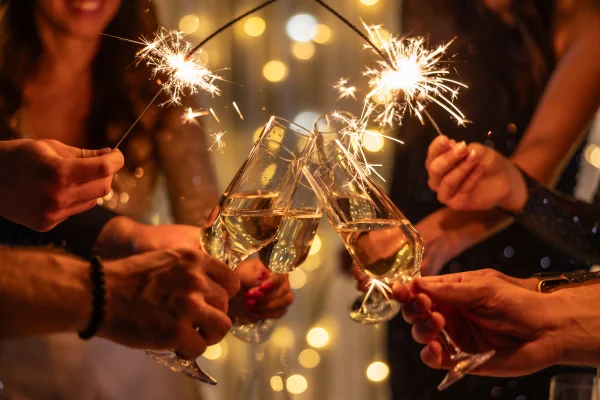 Foto colorida de pessoas brindando taças, amigos celebrando festas de fim de ano - Felicidade tóxica? Como lidar com a pressão por alegria no fim do ano - Metrópoles