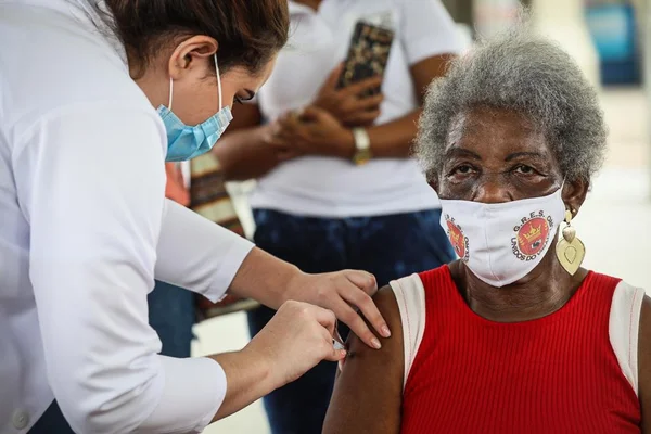 Primeira porta bandeira da Viradouro, Edna Maria Pereira, de 86 anos, recebe a vacina contra a Covid-19