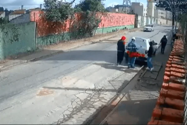 Imagem colorida de prestador de serviços da Comgás sendo vítima de assalto por três criminosos na zona leste de SP - Metrópoles