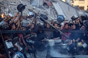 Palestinians gather at a food distribution point in Gaza City, on July 20, 2025. The World Food Programme says nearly one in three people in Gaza do not eat for days at a stretch, and ''thousands'' are ''on the verge of catastrophic hunger''. (Photo by Majdi Fathi/NurPhoto via Getty Images)
