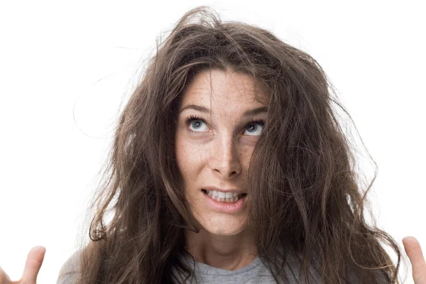 Foto de mulher com semblante assustado e o cabelo bagunçado - Metrópoles