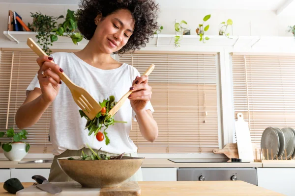 mulher preparando um prato de salada