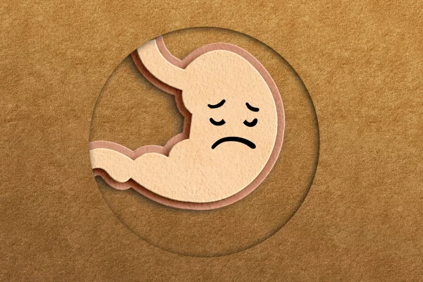 Imagem conceitual de um estômago feito de feltro com uma carinha triste. Dor de estômago. Metrópoles