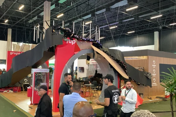 Imagem colorida de stand caído durante evento. Metrópoles