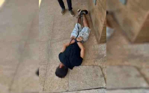 Homem deitado com as mãos amarradas