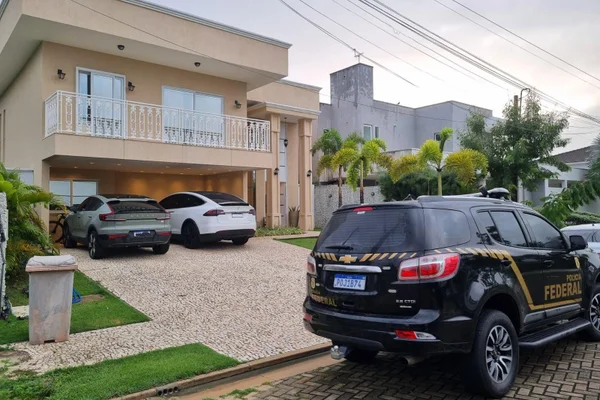 Mansão com carros na garagem e viatura da PF na Frente
