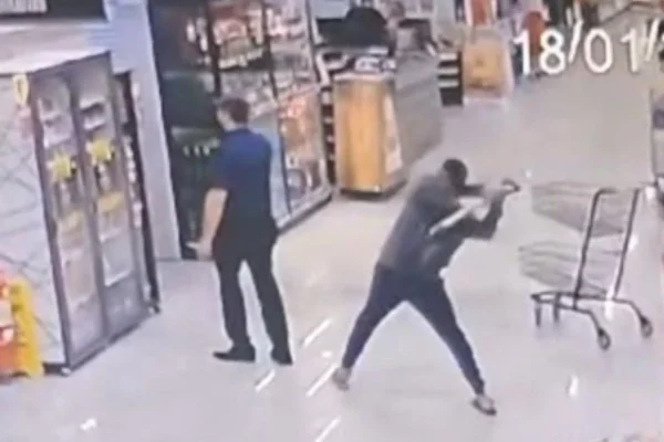 Foto colorida de homem atacando gerente com pá - Metrópoles